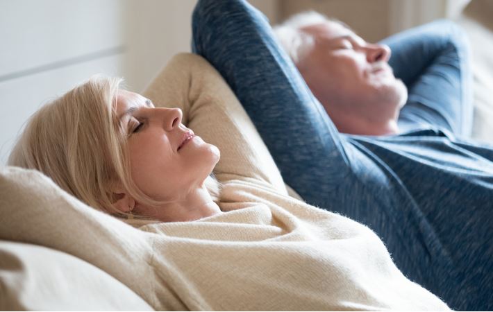 a middle-aged couple relaxing at home