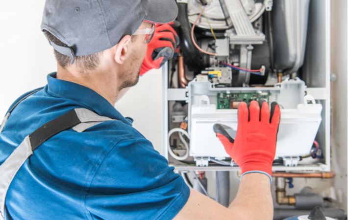 Technician Repairing Furnace