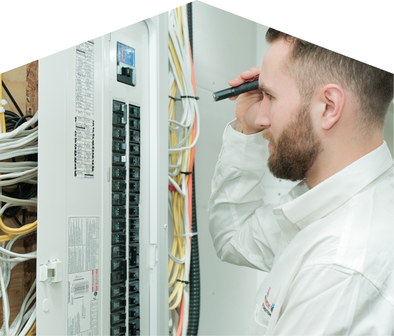 Furnasman electrician inspecting residential electrical panel wiring with a flashlight, checking connections and circuit labels. Furnasman electrician inspecting residential electrical panel wiring with a flashlight, checking connections and circuit labels.
