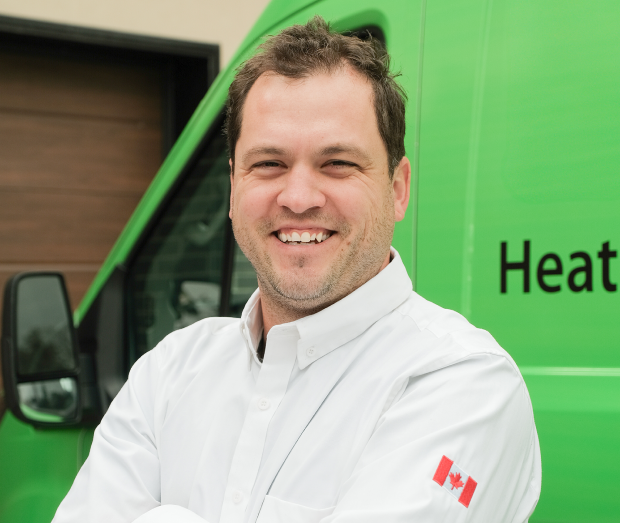 Smiling Furnasman technician standing confidently in front of their green service van, wearing their white issued uniform. Smiling Furnasman technician standing confidently in front of their green service van, wearing their white issued uniform.