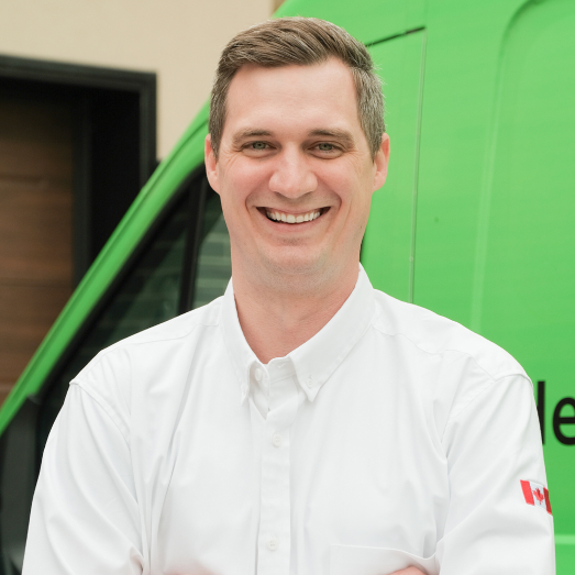 Furnasman technician standing by our famous green trucks in a residential neighbourhood. Furnasman technician standing by our famous green trucks in a residential neighbourhood.